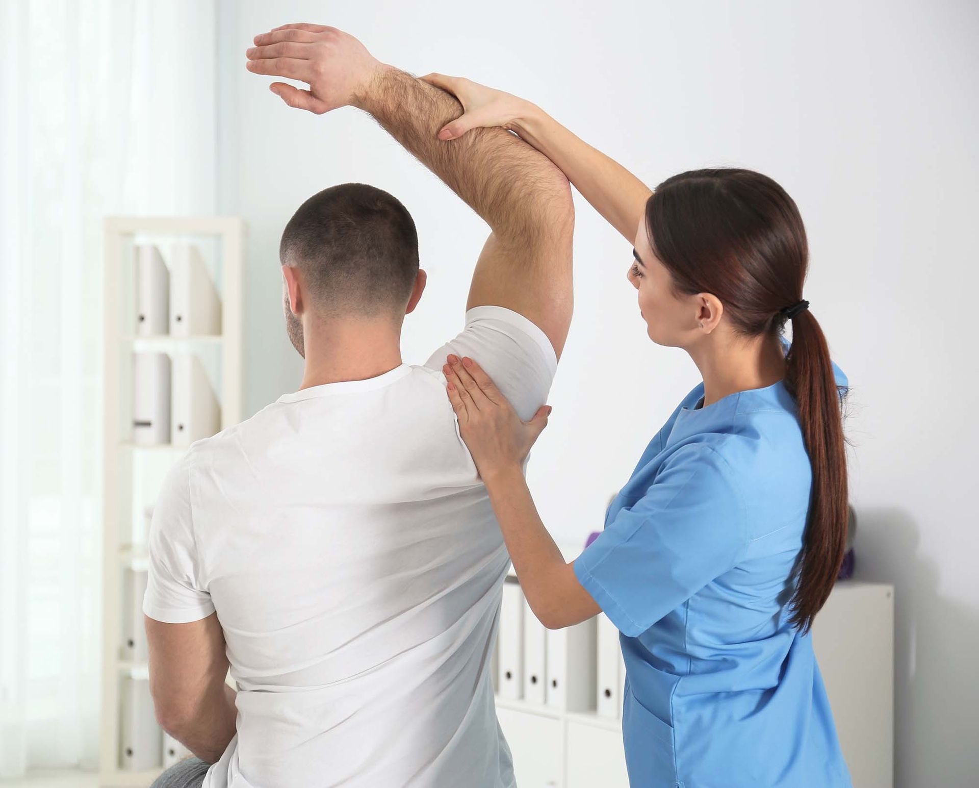 Physiotherapist assessing a patient